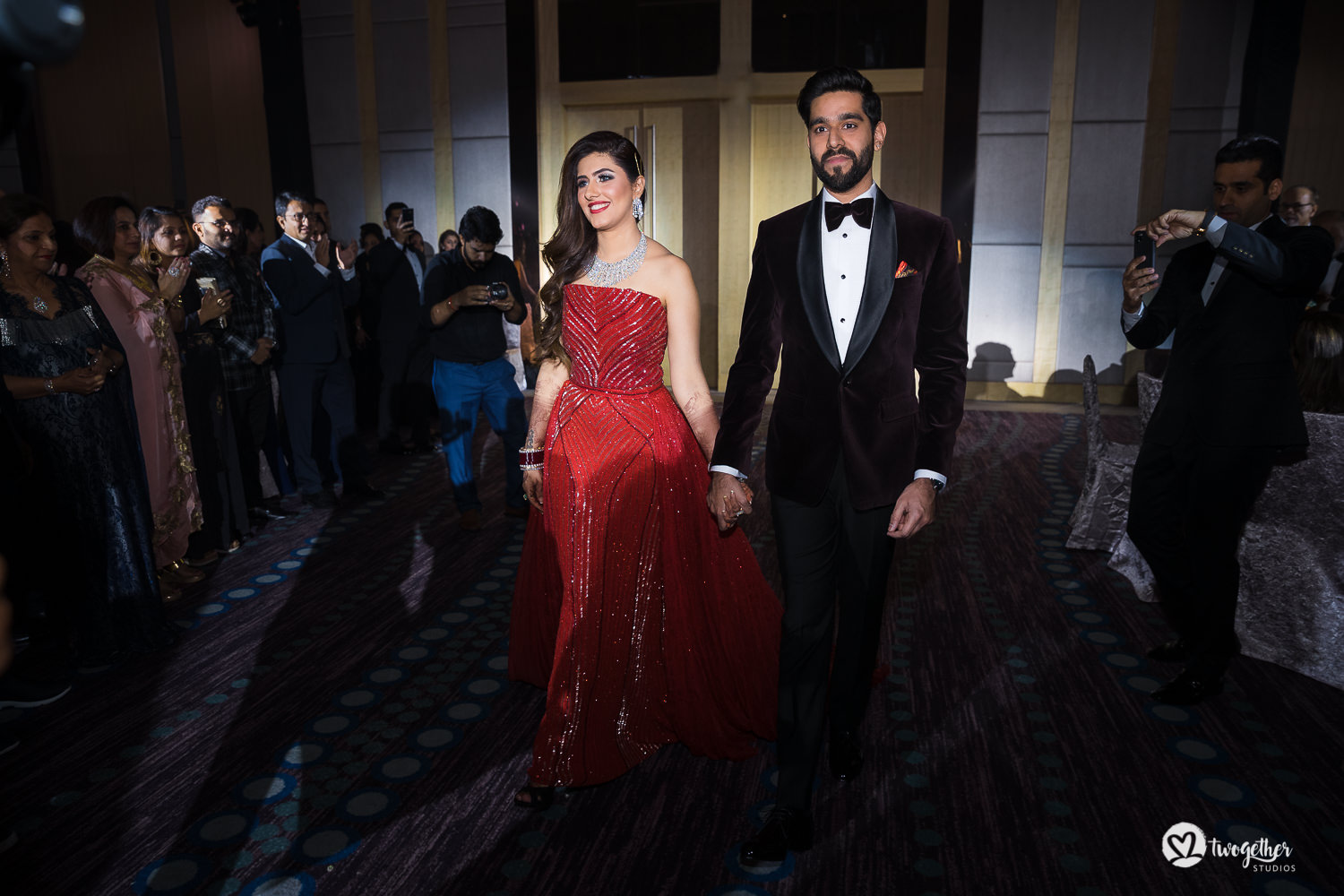 Indian couple enter their reception at Bangkok destination wedding.