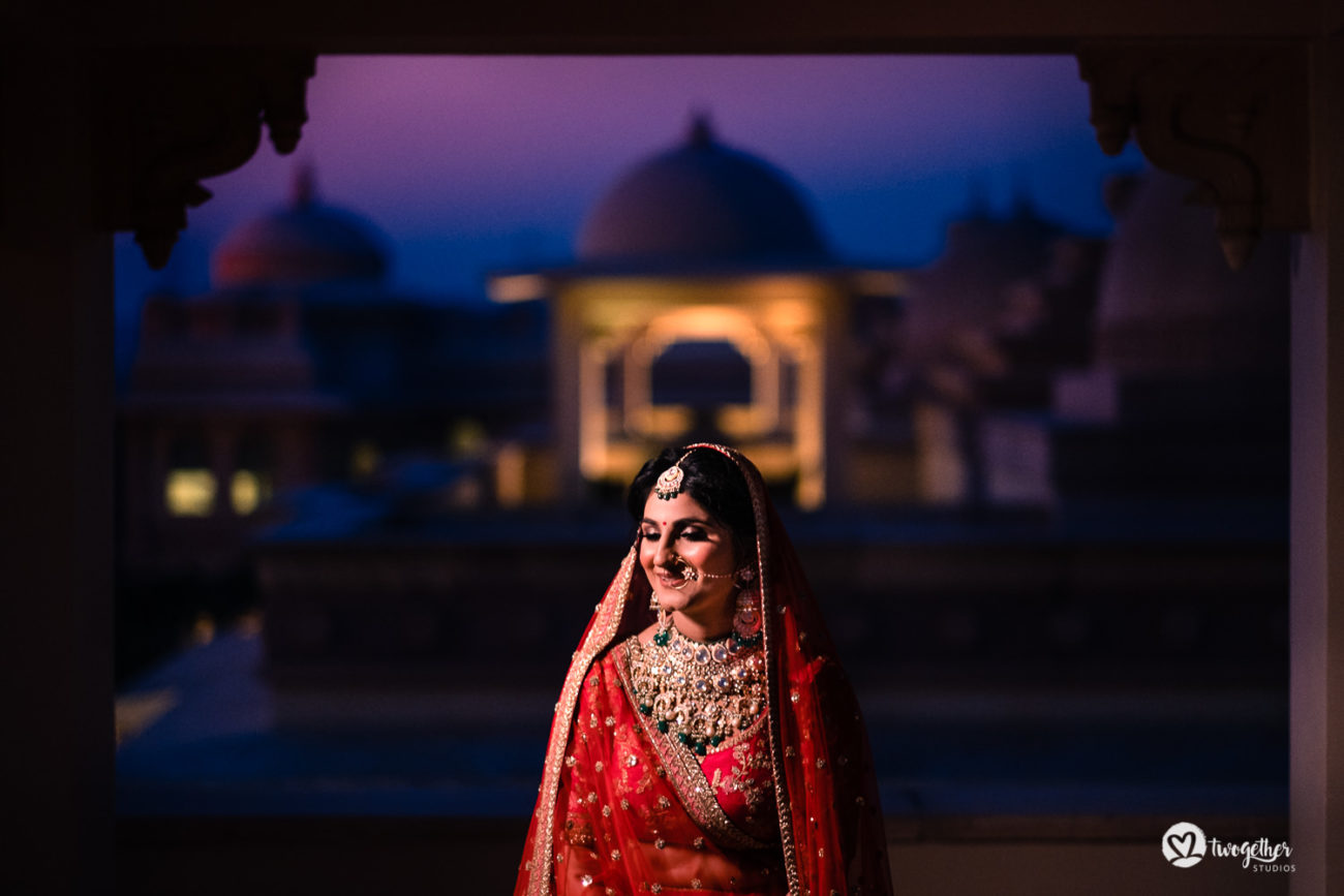 Indian bride in a red Sabyasachi lehenga in an ITC Grand Bharat wedding.