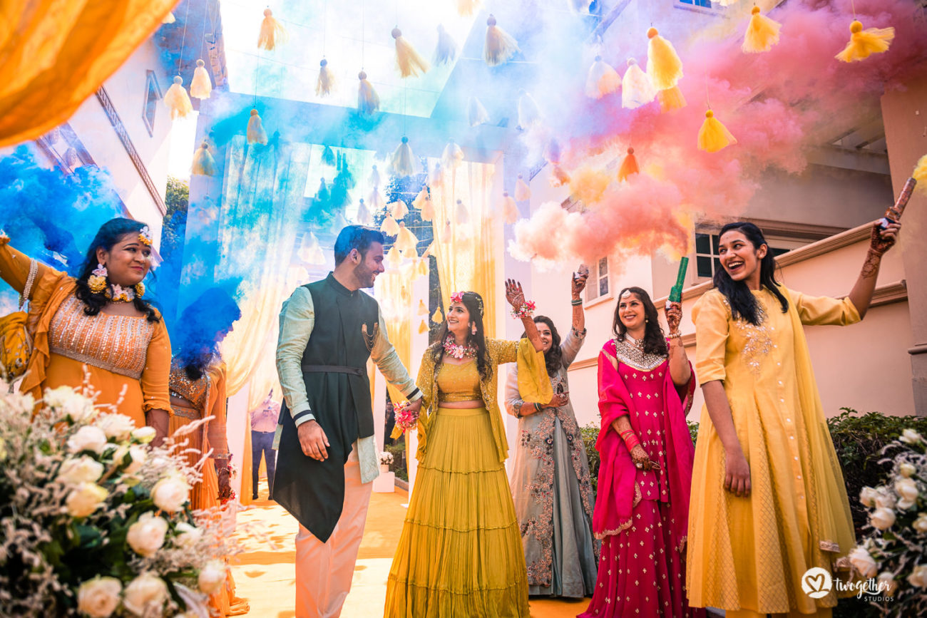 Colour bomb couple entry in an ITC Grand Bharat wedding.