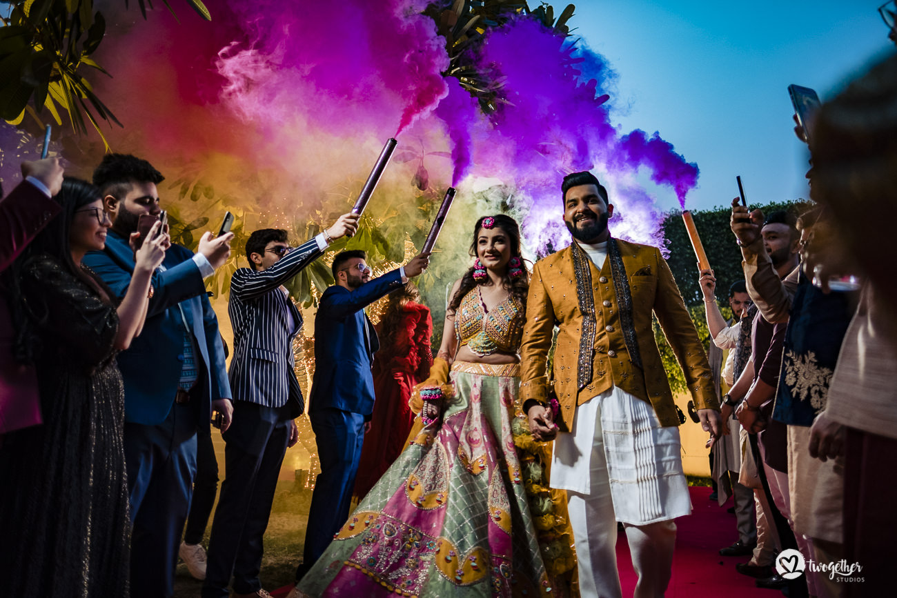 Indian couple enters their mehendi event in a Delhi wedding.